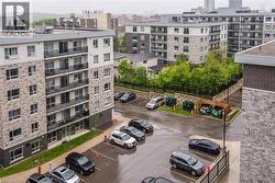 View of property with uncovered parking and a view of city - 