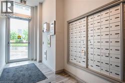 Foyer with mail area, baseboards, and light wood-type flooring - 