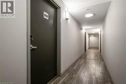 Hall featuring dark wood finished floors and baseboards - 