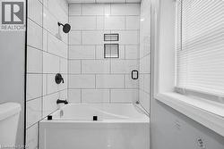 Bathroom featuring shower / bathtub combination and toilet - 