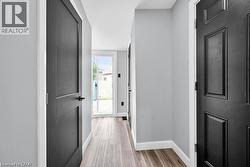 Hall featuring baseboards and light wood-style floors - 