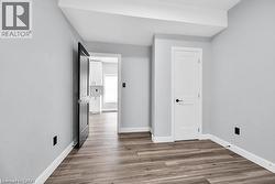 Unfurnished bedroom with light wood-style floors and baseboards - 