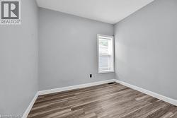 Empty room with baseboards and wood finished floors - 