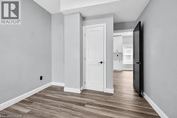 Unfurnished room with dark wood-style flooring - 