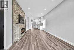 Unfurnished living room with light wood-style floors, recessed lighting, and a fireplace - 