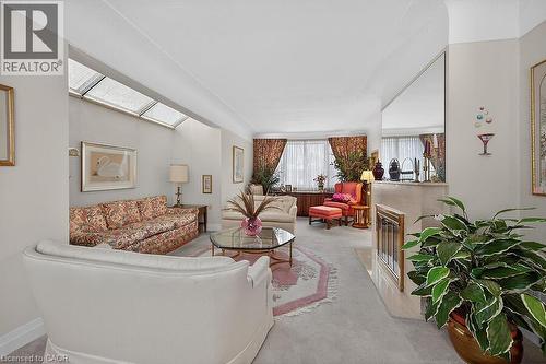 Living room featuring a fireplace and light carpet - 9 Daleview Court, Hamilton, ON - Indoor