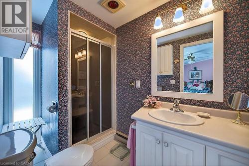 Bathroom with vanity, a stall shower, light tile patterned floors, and wallpapered walls - 9 Daleview Court, Hamilton, ON - Indoor Photo Showing Bathroom