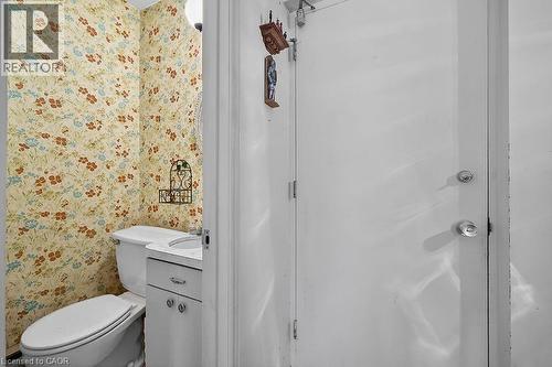 Half bath with vanity and wallpapered walls - 9 Daleview Court, Hamilton, ON - Indoor Photo Showing Bathroom