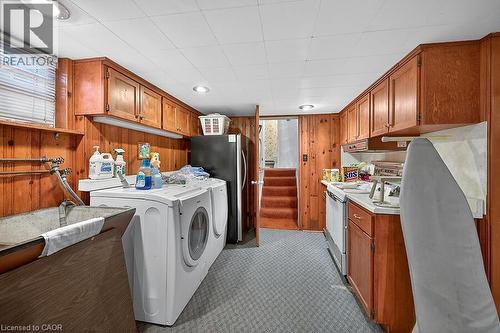Laundry area with wood walls and independent washer and dryer - 9 Daleview Court, Hamilton, ON - Indoor Photo Showing Laundry Room