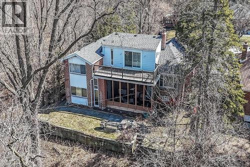 Rear view of property featuring a shingled roof and a sunroom - 9 Daleview Court, Hamilton, ON - Outdoor With Deck Patio Veranda