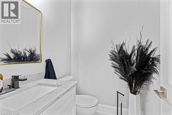 Half bathroom featuring toilet and vanity - 