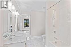 Bathroom with toilet, shower / washtub combination, marble finish floor, and a sink - 