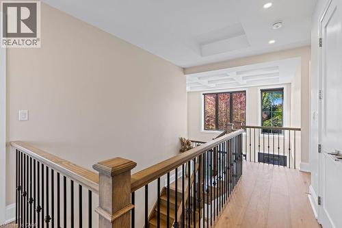 Hallway with an upstairs landing, recessed lighting, light wood finished floors, a tray ceiling, and baseboards - 308 Appleby Line, Burlington, ON - Indoor Photo Showing Other Room