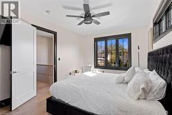 Bedroom featuring a ceiling fan and light wood-style flooring - 