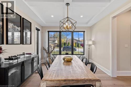 Dining area featuring light wood-type flooring, recessed lighting, an inviting chandelier, a raised ceiling, and baseboards - 308 Appleby Line, Burlington, ON - Indoor Photo Showing Dining Room