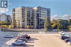 View of apartment building / complex with uncovered parking - 