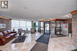 Community lobby featuring a textured ceiling and expansive windows - 