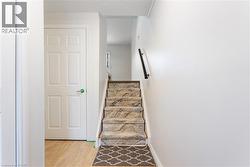Stairway with wood finished floors and baseboards - 