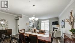Dining space with a fireplace, ornamental molding, a chandelier, dark wood-type flooring, and a textured ceiling - 
