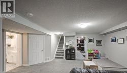 Game room featuring a textured ceiling and light colored carpet - 