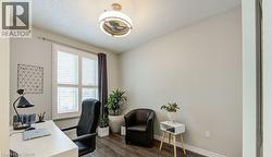 Office area featuring dark wood-type flooring and baseboards - 