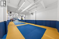 View of home's community featuring community basketball court and a wainscoted wall - 