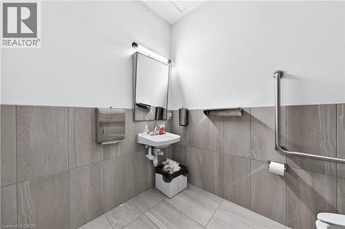 Half bathroom with tile walls and pet washing area - 26 Main Street, Cambridge, ON 