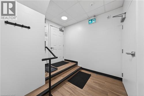 Hallway featuring a drop ceiling, light wood-style floors, and recessed lighting - 26 Main Street, Cambridge, ON 