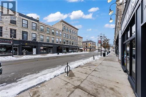 View of asphalt road featuring street lights and sidewalks - 26 Main Street, Cambridge, ON 