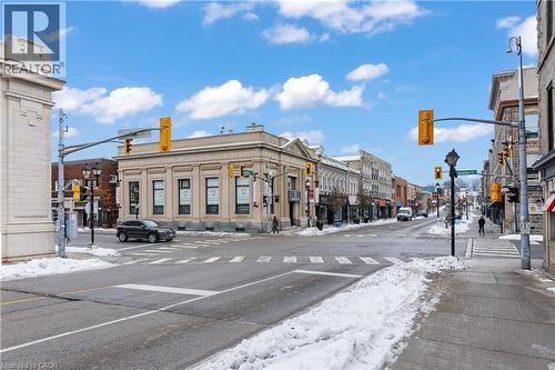 View of asphalt road with traffic lights, street lights, sidewalks, traffic signs, and curbs - 26 Main Street, Cambridge, ON 