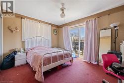 Bedroom featuring a textured ceiling, carpet, access to exterior, and ceiling fan - 