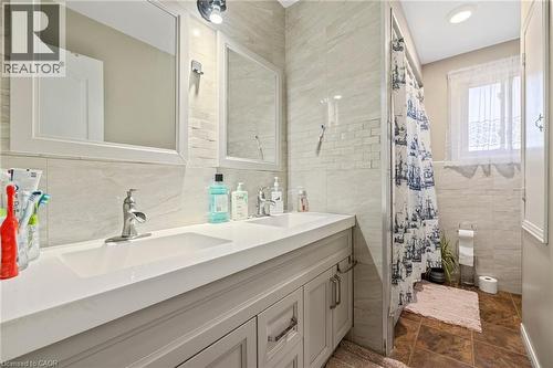 Full bathroom featuring tile walls, double vanity, and curtained shower - 490 Queen Victoria Drive, Hamilton, ON - Indoor Photo Showing Bathroom