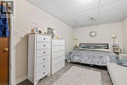 Bedroom with a drop ceiling and carpet flooring - 