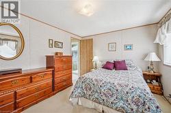 Bedroom featuring light colored carpet, a textured ceiling, and ornamental molding - 
