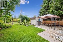 Fenced backyard featuring a gazebo, a patio, and a storage shed - 