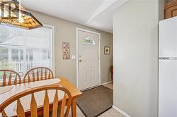 Foyer entrance featuring a textured ceiling and baseboards - 