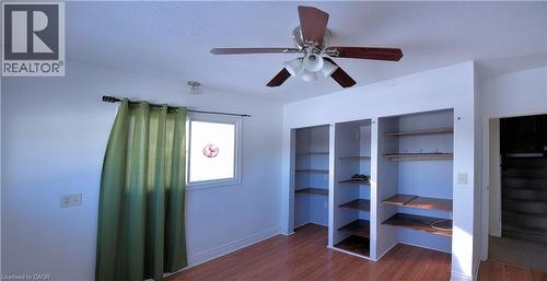 Unfurnished bedroom with dark wood-type flooring, a ceiling fan, and a textured ceiling - 1448 Upper Ottawa Street, Hamilton, ON - Indoor