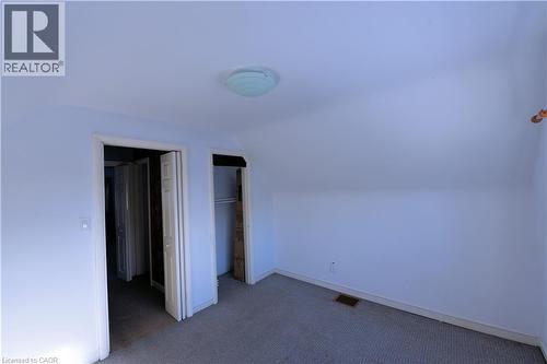 Additional living space featuring dark carpet and vaulted ceiling - 1448 Upper Ottawa Street, Hamilton, ON - Indoor