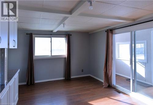 Unfurnished room featuring beam ceiling and dark wood-style floors - 1448 Upper Ottawa Street, Hamilton, ON - Indoor Photo Showing Other Room