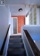 Stairs featuring wallpapered walls - 
