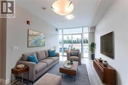 Living room featuring floor to ceiling windows and light wood finished floors - 