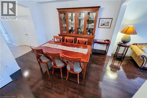 Dining area featuring arched walkways and dark wood finished floors - 3362 Whilabout Terrace, Oakville, ON - Indoor Photo Showing Dining Room