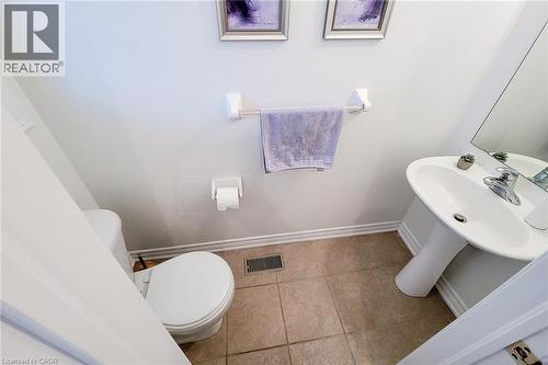 Main floor half bathroom featuring baseboards and tile patterned flooring - 3362 Whilabout Terrace, Oakville, ON - Indoor Photo Showing Bathroom