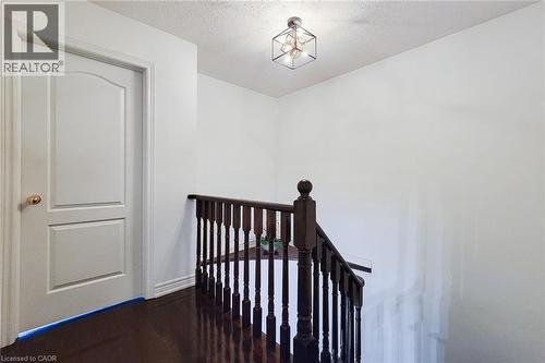 Stairway with a textured ceiling and wood finished floors - 3362 Whilabout Terrace, Oakville, ON - Indoor Photo Showing Other Room