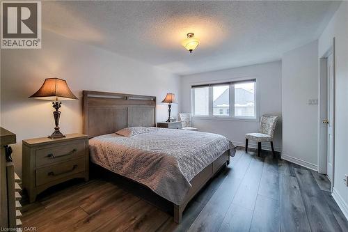Primary bedroom with a textured ceiling and dark wood finished floors - 3362 Whilabout Terrace, Oakville, ON - Indoor Photo Showing Bedroom