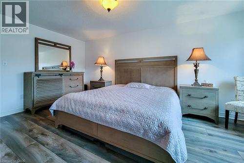 Primary bedroom with wood finished floors and a textured ceiling - 3362 Whilabout Terrace, Oakville, ON - Indoor Photo Showing Bedroom