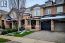 View of front of property featuring an attached garage, a balcony, stone siding, and driveway - 3362 Whilabout Terrace, Oakville, ON  - Outdoor With Facade 