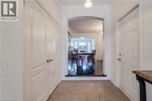 Foyer looking towards living room featuring arched walkways and light tile patterned floors - 3362 Whilabout Terrace, Oakville, ON - Indoor Photo Showing Other Room