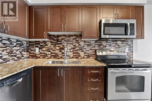1940 Ironstone Drive Unit# 1006, Burlington, ON - Indoor Photo Showing Kitchen With Double Sink