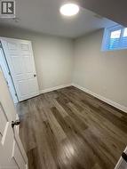 Below grade area with dark wood finished floors and baseboards - 